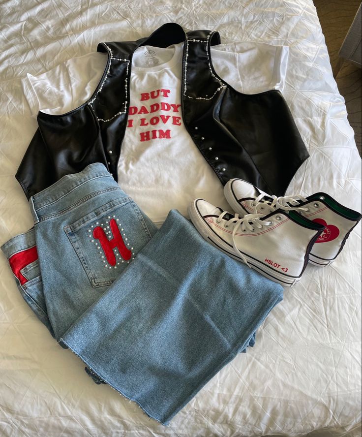 a pair of high waisted shorts, white shirt and black vest with red letters on it