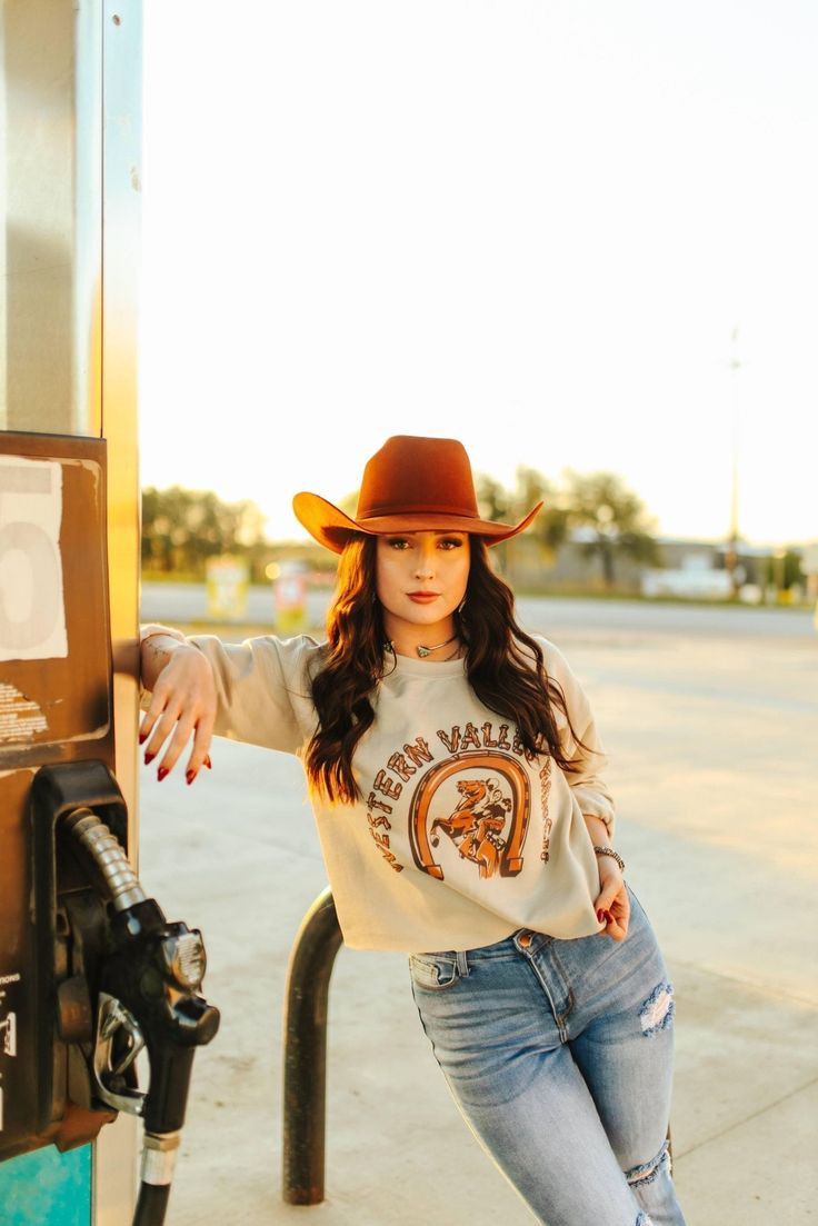 Saddle up and ride into style with our Western Valley Ranch Raw Hem Graphic Sweater! This tee features a rustic and charming design complete with a horseshoe and a cowboy on horseback. Made from soft, high-quality fabric, this tee is as comfortable as it is stylish. Made in the USA Real Turquoise Jewelry, On Horseback, Graphic Sweaters, Real Turquoise, Plus Size Shopping, Dress Romper, Long Sweaters, Hat Hairstyles, Short Tops