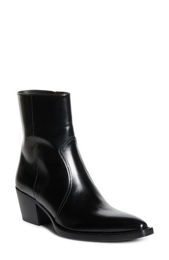 A stacked, slanted heel offers a bold boost to this Western-inspired leather boot with an upturned toe that creates an effect of perpetual movement. 1 3/4" heel Inset side-zip closure Leather upper, lining and sole Made in Italy Designer Shoes Classic Ankle Boots With Stacked Heel, Classic High Ankle Boots With Stacked Heel, Modern Chelsea Boots With Sculpted Heel For Work, Classic Ankle Boots With Heel Pull Tab, Medium Fit Ankle Boots With Reinforced Heel, Classic Heeled Boots For Work With Heel Pull Tab, Modern Round Toe Boots With Stacked Heel, Western Calf Leather Boots For Workwear, Sleek High Ankle Heeled Boots With Stacked Heel