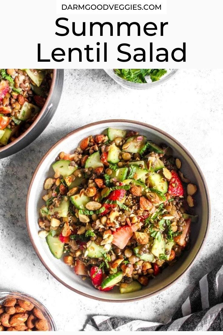 two bowls filled with lentil salad on top of a white table next to other dishes