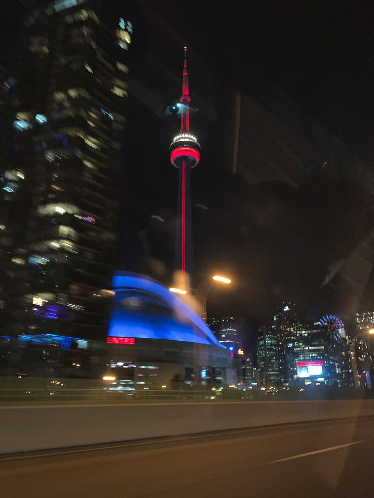 the city skyline is lit up in red, white and blue