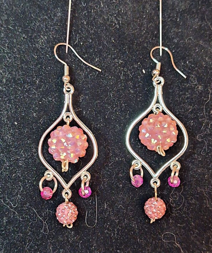 A cluster of pink diamonds dominate these earrings Elegant Pink Cluster Earrings, Glamorous Pink Earrings For Gift, Pink Teardrop Beaded Earrings For Party, Pink Sterling Silver Earrings For Pierced Ears, Pink Dangle Flower Earrings, Nickel-free Pink Dangle Flower Earrings, Pink Dangle Crystal Earrings With Sparkling Stones, Pink Dangle Flower Earrings Nickel Free, Pink Sparkling Stones Dangle Crystal Earrings