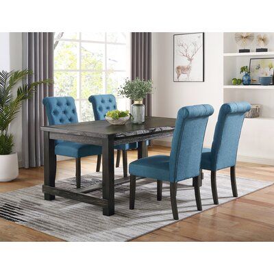 a dining room table with blue chairs around it