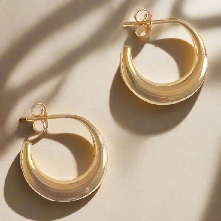 These solid earrings are immensely sleek and of a timelessly attractive form, and are based on examples from ancient Cyprus. Known as "boat" earrings, they feature a gently swollen crescent shape, and a post back. "Tullia" is the female patronymic of the family name Tullius. One famous Tullia was the beloved daughter of Marcus Tullius Cicero (106 - 43 BC), famous orator and statesman of the Late Republic. Cicero had only one daughter, and he was completely devoted to her. When she sadly predecea Timeless 14k Gold Earrings With Polished Finish, Elegant 14k Gold Half Moon Jewelry, Refined 14k Gold Round Earrings, Elegant Half Moon 14k Gold Jewelry, Elegant Half Moon Yellow Gold Jewelry, Everyday Crescent Single Earring, Timeless Sterling Silver Jewelry, Timeless Polished Huggie Earrings, Timeless Rounded Sterling Silver Jewelry