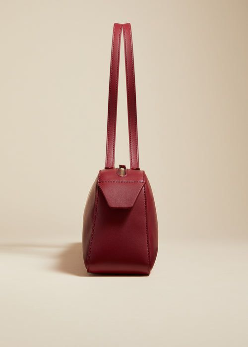 Simona Shoulder Bag in Oxblood Leather Elegant Shoulder Bag With Long Strap, Elegant Everyday Baguette Bag With Detachable Strap, Elegant Evening Shoulder Bag With Long Strap, Classic Top Handle Baguette Bag, Timeless Structured Shoulder Bag, Elegant Everyday Baguette Bag, Elegant Structured Formal Shoulder Bag, Modern Formal Baguette Bag With Detachable Strap, Elegant Rectangular Bag With Long Strap