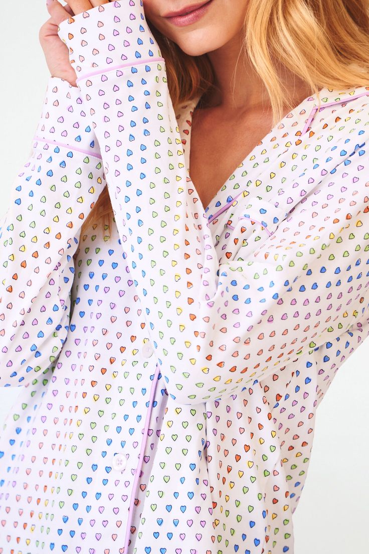 Stay cozy in bed in these new soft and plush PJs that feature our chic hearts print in a vibrant multi-rainbow colorway. This pajama set includes a long-sleeve polo top and matching bottoms. 4 Buttons Chest Pocket Elastic Waistband Materials and Care 100% Premium Cotton Cold Wash, with like colors. Do not bleach Tumble dry low (Line dry recommended). Warm iron if needed Imported Measurement Information Model Wears Size Small Size S Length: 25" (from Shoulder) Size S Sleeve Length: 24" (from Shou Playful Multicolor Sleepwear For Loungewear, Multicolor Long Sleeve Sleepwear For Lounging, Playful Long Sleeve Sleepwear For Pajama Party, Multicolor Relaxed Fit Sleepwear For Pajama Party, Playful Multicolor Sleepwear For Pajama Party, Multicolor Printed Sleepwear For Sleepover, Multicolor Long Sleeve Loungewear Sleepwear, Multicolor Long Sleeve Sleepwear For Loungewear, Multicolor Relaxed Fit Sleepwear For Bedtime