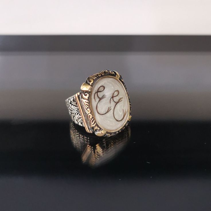 "✓ Personalized Hair Locket Initial Ring For Men. Our Solid 925 Sterling Silver ring with; %100 hand crafted, gold workmanship is specially produced for you, Jewelry made with love for your special occasions. ---● R I N G ∙ D E T A I L S ●--- * The Case Of The Ring is SOLID 925 STERLING SILVER. * The upper part of the ring is made of UV stable resin. And your hair will be safe in it. * We create letters/designs by hand crafted by separating your hair into strands. * The shapes of the letters/des Victorian Engraved Rings For Memorial, Victorian Engraved Memorial Rings, Victorian Memorial Jewelry Ring, Victorian Enamel Ring Engraved For Anniversary, Victorian Oval Rings With Engraving Option, Victorian Engraved Enamel Ring For Anniversary, Victorian Oval Ring With Engraving Option, Victorian Rings With Engraving Option For Anniversary, Unique Oval Jewelry For Memorial