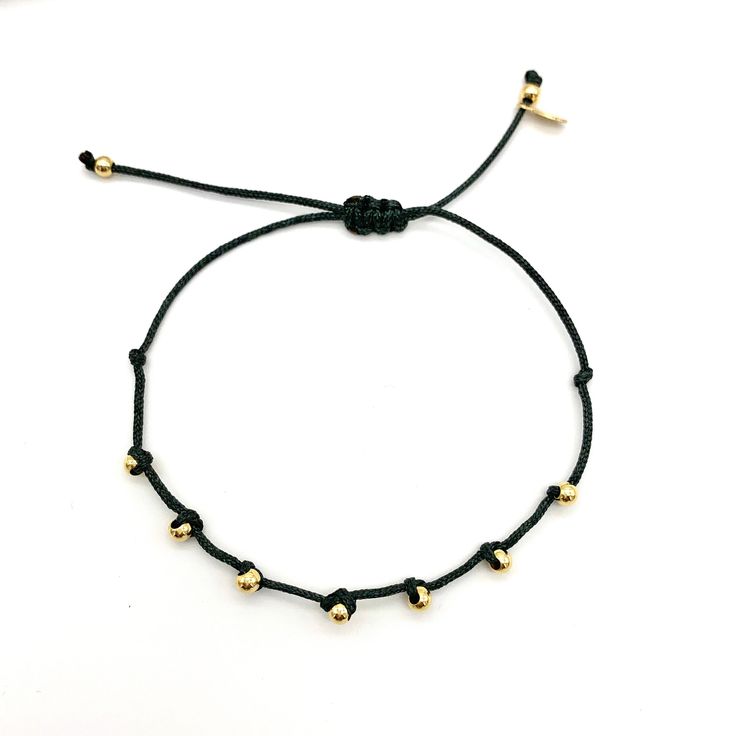 Dainty and minimal Bracelet with beads. Fashion forward delicate and essential! This bracelet is adjustable with macrame knot to fit almost every wrist size. Please choose color of string in options. D E T A I L S: M A T E R I A L S: * Beads 14K Gold Plated * Cotton cord SIZE * Beads: 3.2mm aprox * Bracelet is adjustable C R A F T S M A N S H I P ∙ & ∙ L O V E: * Hand-made by me * Happiness guarantee: we want you to LOVE your new jewelry! S E E ∙ O U R ∙ S H O P Be sure to check out more bea Trendy Adjustable Gold Beads Friendship Bracelets, Trendy Adjustable Friendship Bracelets With Gold Beads, Minimalist Gold Beaded Friendship Bracelets, Minimalist Friendship Bracelets With Gold Beads, Minimalist Friendship Bracelets With Sliding Knot, Minimalist Everyday Friendship Bracelets With Adjustable Length, Gold Beads Bracelet, String Friendship Bracelets, Cotton Cord Bracelet