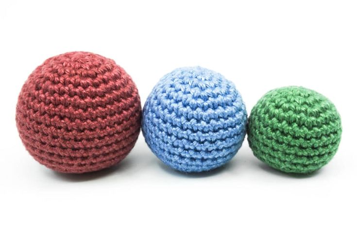 three crocheted balls sitting next to each other