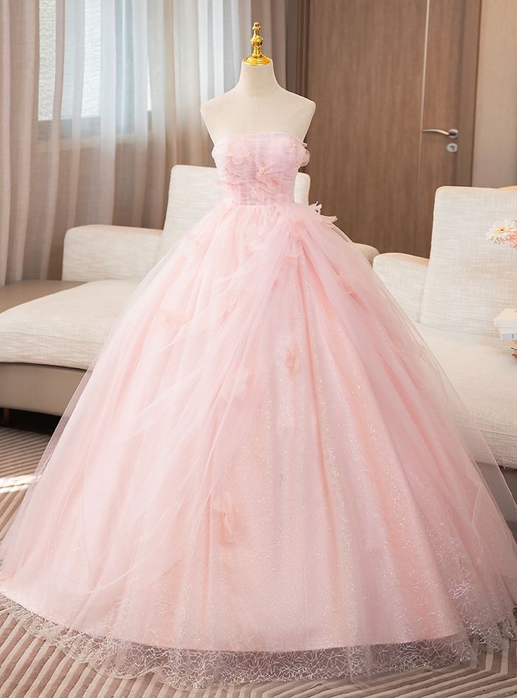 Fearlessly feminine, this exquisite prom dress is pure romance! Designed to make you feel like the belle of the ball, the soft pink hue and sparkling tulle fabric combine for an effect thatas dreamy as it is elegant. The structured bodice, with its delicate floral accents, creates a flattering silhouette while offering ample support for a night full of dancing and celebration. The floor-length skirt flows in gentle waves, adding a graceful movement with every step you take. Light, airy, and full of subtle shimmer, the dress ensures that all eyes will be on you throughout the evening. The strapless neckline adds a touch of modern elegance, perfectly balancing the gownwhimsical and classic features. Ideal for prom-goers who want a gown that exudes femininity and charm, this dress is not only Light Pink 15 Dresses, Light Pink Ball Gown, Light Pink Quinceanera Dresses, Princess Pink Dress, Vintage Simple Wedding Dress, Beach Wedding Dresses Backless, Pink Sweet 16, Quinceanera Dresses Pink, Graceful Movement