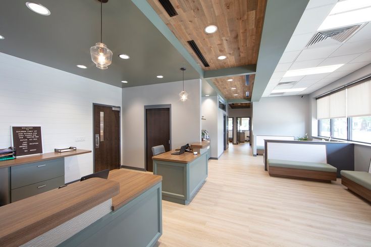 the interior of an office building with wood floors