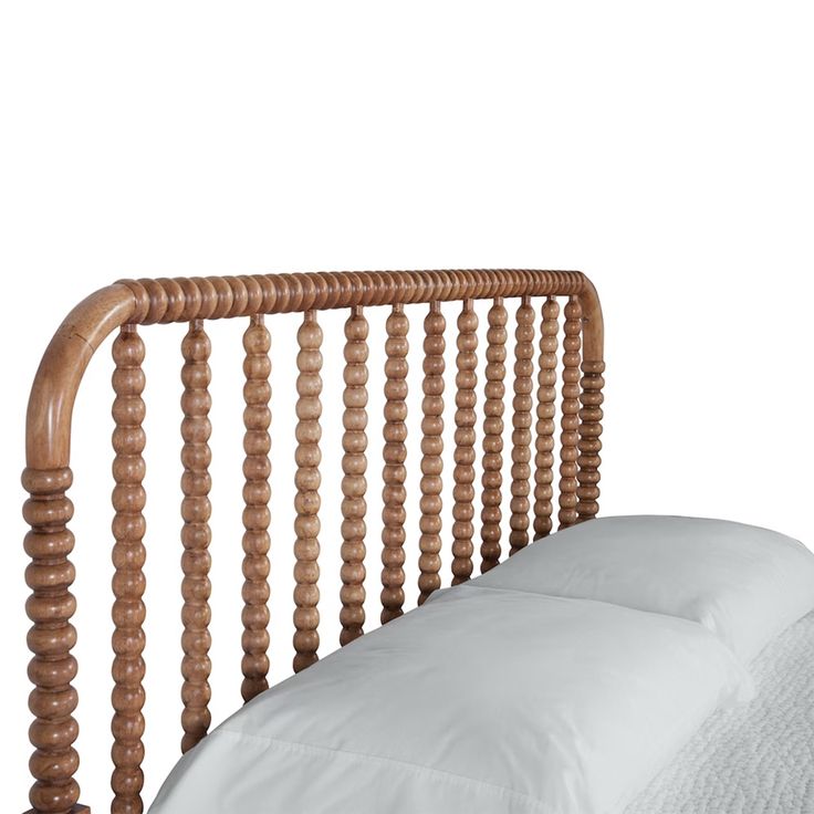 a wooden headboard with white sheets and pillows on the bottom bed, against a white background