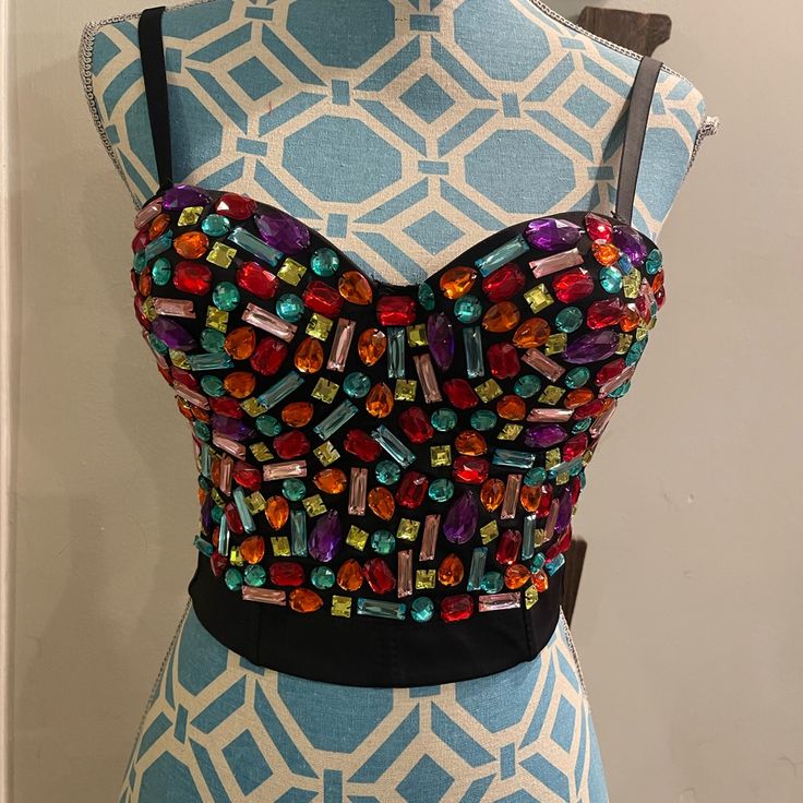 Add Some Vibrancy To Your Wardrobe With This Amazing Bejeweled Bustier. The Bustier Comes With Colorful Accents That Enhance Its Beauty. It Has Removable Straps That Give You The Freedom To Wear It As A Tank Top Or A Strapless Top. This Tank Top Is Perfect For Any Casual Or Formal Occasion And Is Available In Size L. The Bustier Has Multiple Closures For A Comfortable Fit. Rhinestone Crop Top For Club Parties, Rhinestone Crop Top For Club And Party Season, Rhinestone Crop Top For Club Party Season, Embellished Crop Top For Club And Party Season, Glamorous Rhinestones Crop Top For Party Season, Embellished Crop Top For Party Season, Glamorous Fitted Crop Top With Rhinestones, Multicolor Crop Top For Summer Party, Summer Party Multicolor Crop Top