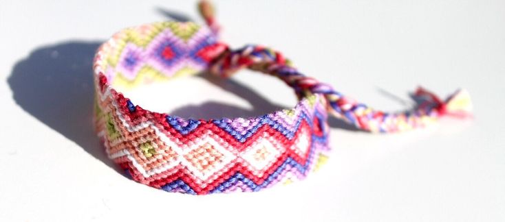 *BRACELET DETAILS  Beautiful handwoven friendship bracelet with a tie dye pattern and the colors of Dark Pink, Pink, Purple, Light Purple, Light Green, Coral and White.  The woven part of this bracelet is 2 centimeters wide and 14 centimeters long. There are braided ties on both ends. This bracelet is made out of 100% premium cotton which not only means the colors are long lasting but also it lightweight to wear.  Packaging holder is made from recycled cardboard material.  *SHIPPING FREE US shipping! International shipping available too! This bracelet will ship 1-4 business days from Rochester, Michigan USA. *ADD STACKABLE BRACELETS Add some thin and simple stacking bracelets to your order. Simple bracelets are great for stacking/layering with other bracelets.  Add them to your order by fo Purple Resizable Bracelets For Friendship, Bohemian Purple Resizable Bracelets, Multicolor Friendship Jewelry, Bohemian Rainbow Resizable Jewelry, Colorful Adjustable Unique Bracelets, Colorful Adjustable Bracelets, Adjustable Colorful Unique Bracelet, Colorful Adjustable Bracelet, Red Hippie Beaded Bracelets For Gift