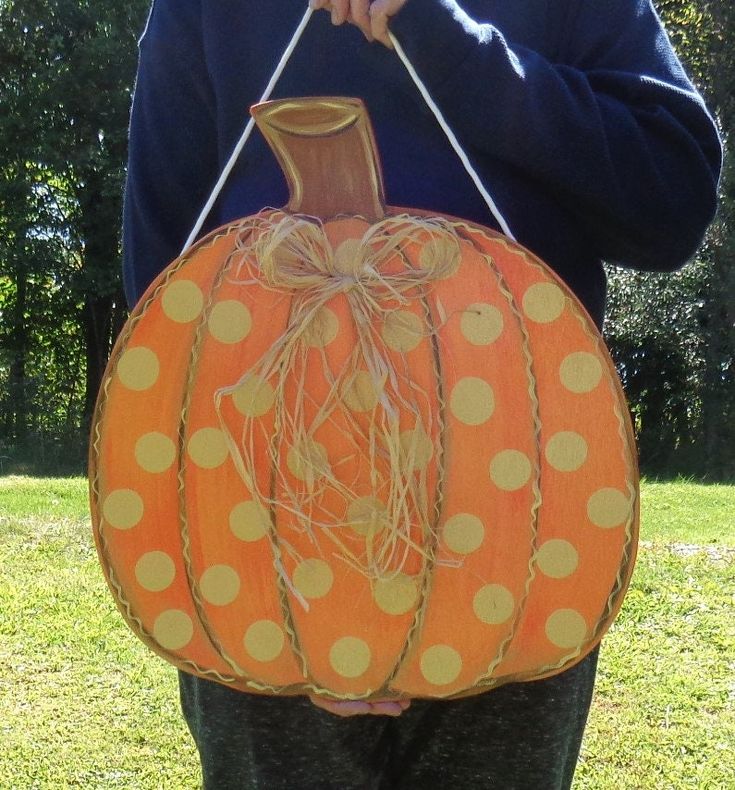 a man is holding a pumpkin shaped basket