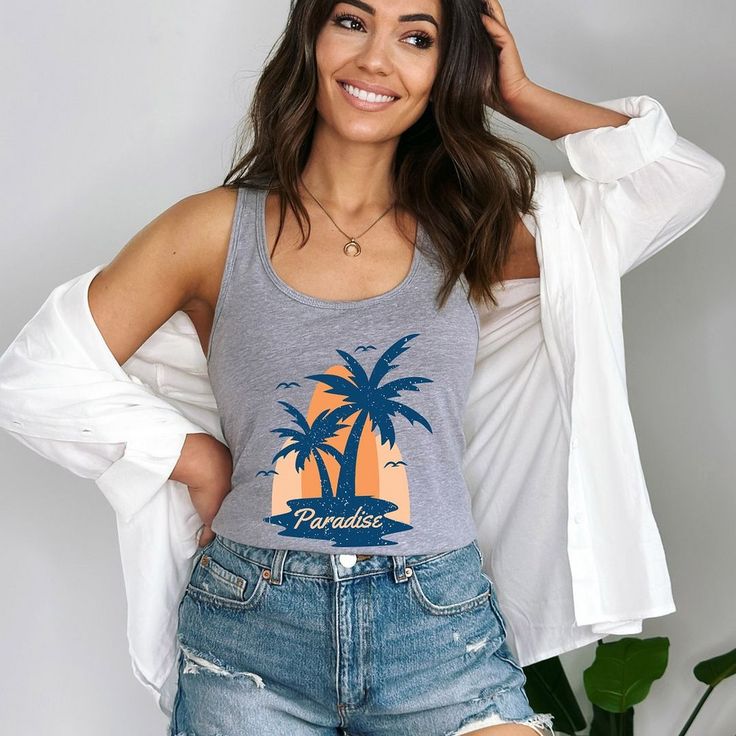 Looking for a cute versatile top to wear? Make sure to grab one of our Graphic Tanks! This soft and comfortable graphic Tank is the perfect top for any outfit. It can be paired with biker shorts, jeans, or even a simple skirt/dress! This Tank is true-to-size, so be sure to order your regular t-shirt size! If you are looking for a more oversized look, make sure to size up! Casual Racerback Top With Graphic Print, Casual Racerback Tops With Letter Print, Casual Summer Racerback T-shirt, Casual Scoop Neck Tank Top With Letter Print, Casual Printed Scoop Neck Tops, Casual Cotton Racerback T-shirt, Casual Racerback T-shirt For Summer, Summer Crew Neck Tank Top With Graphic Print, Casual Graphic Print Tank Top For Everyday