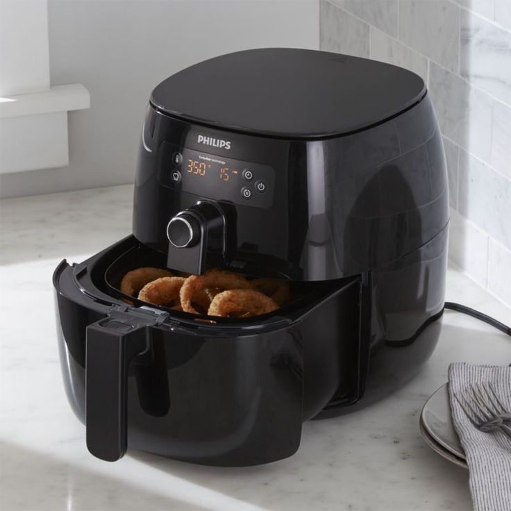 an air fryer with some fried food in it