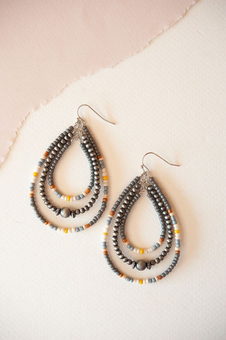 Introducing the Brodie Beaded Teardrop Dangle Earrings, a celebration of vibrant colors and artistic design. These earrings feature teardrop-shaped dangles adorned with a captivating array of multicolored beads, creating a bold and eye-catching look. Perfect for adding a playful and eclectic touch to your outfit, they effortlessly complement both casual and festive attire with their unique charm and dynamic hues. The Brodie Beaded Teardrop Dangle Earrings are ideal for those who love to make a s Multicolor Beaded Teardrop Earrings, Multicolor Teardrop Earrings With Dangling Beads, Multicolor Teardrop Jewelry With Colorful Beads, Beaded Teardrop Chandelier Earrings, Multicolor Teardrop Beaded Earrings, Multicolor Teardrop Faceted Bead Jewelry, Bohemian Teardrop Drop Earrings With Dangling Beads, Colorful Beaded Dangle Teardrop Earrings, Multicolor Teardrop Earrings With Colorful Beads