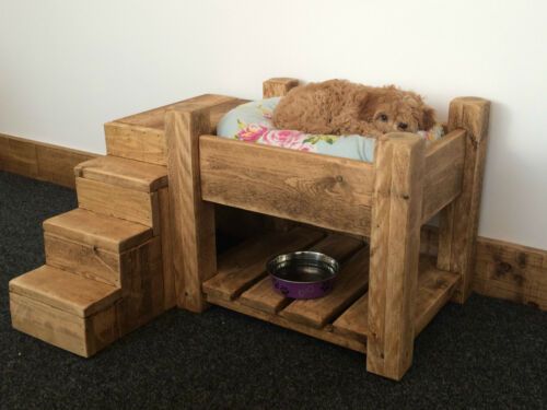 a dog is laying in his bed on the floor next to some stairs and a bowl