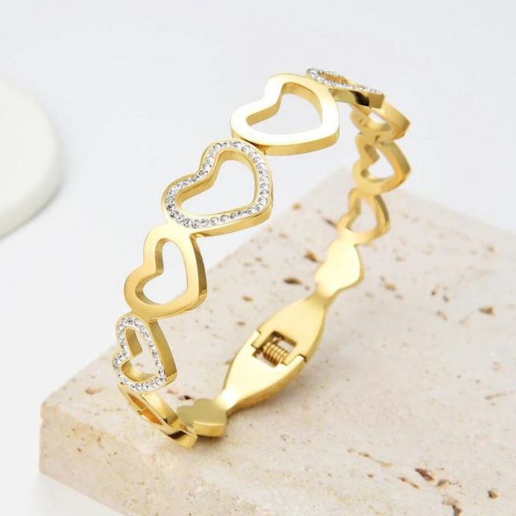 "Style: Gold Open Heart Bangle  Material: Stainless Steel Size:  See Pic 2 for measurements Diameter - 59mm (fits wrist sizes 5.5\" - 6.5\")  SHOW US SOME L♡VE  ♥ Love it and want to buy later? Click \"♥ Add to collection\" ♥ Love it share it on SOCIAL MEDIA with share buttons under the picture ♥ Want it now? Click the green \"Add to cart\" button. ♥ Have questions? Click \"Message SaRatta\" ♥ Want to see more? Click here to see my shop: https://www.etsy.com/shop/ExpressionsBracelets  FOLLOW US FOR MORE  COPYRIGHT NOTICE: Please do not duplicate any creations; all images are protected under copyright. Expressions Bracelets 2023 © ALL product designs are Copyright of Expressions Bracelets." Modern Gold Jewelry, Stackable Bangles, Valentines Day Gifts For Her, Open Heart, Minimalist Jewelry, Bangle Bracelets, Valentine Day Gifts, Gold Jewelry, Cubic Zirconia