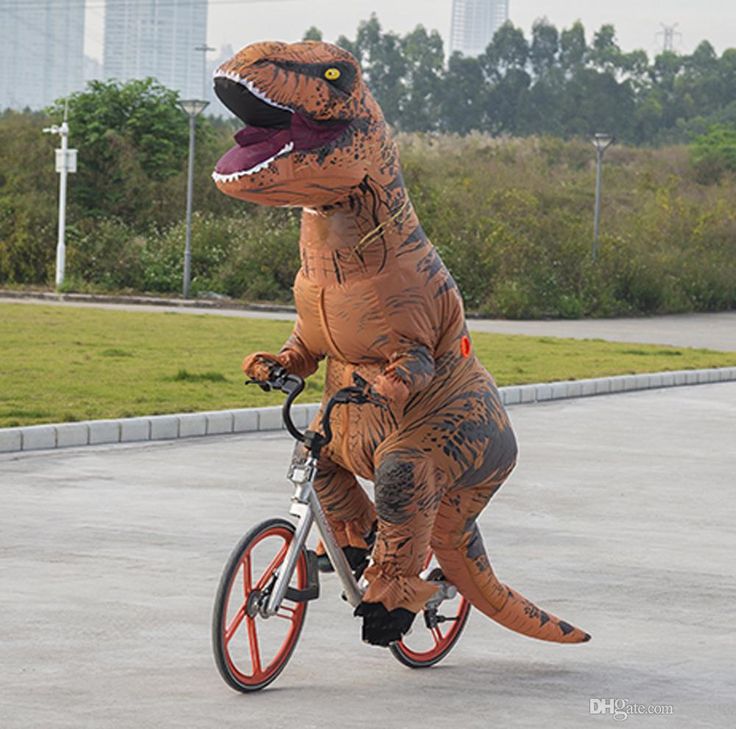 an inflatable dinosaur riding a bicycle