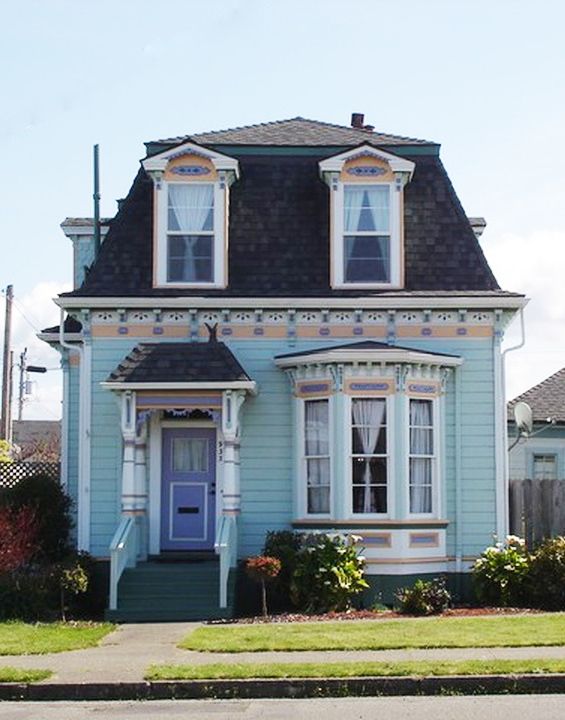 a blue house with white trim and windows