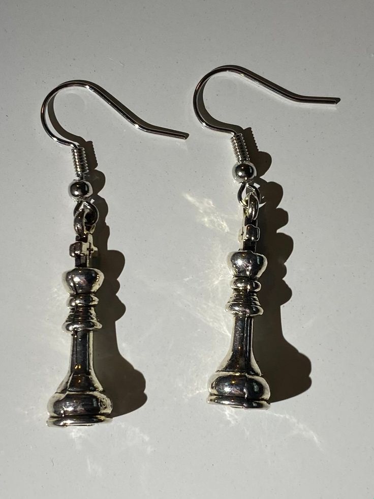 Chess piece dangle earrings. The backings are made of typical craft store metal earring wire so they should not turn your skin green and they should be hypoallergenic. These unique charms were thrifted so I am not sure of the type of metal its made with. The jewelry has been sanitized as well. Message me with any questions! Nickel Free Metal Drop Earrings, Metal Dangle Earrings With Ear Wire, Pierced Metal Pendant Earrings, Dangle Metal Earrings With Ear Wire, Metal Single Dangle Earring, Metal Dangle Earrings, Nickel Free Adjustable Metal Plug Earrings, Nickel Free Metal Pendant Earrings, Adjustable Metal Dangle Earrings