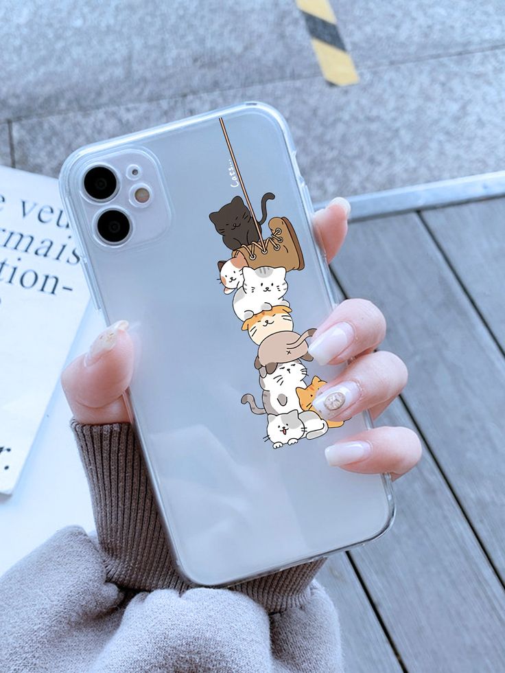 a woman holding up her phone case with cartoon dogs on it