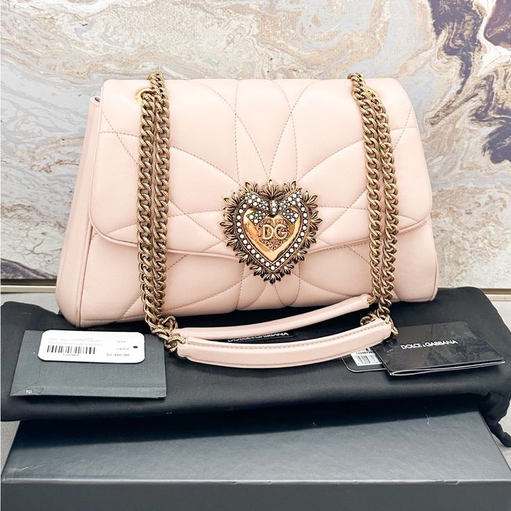 Beautiful Authentic Dolce & Gabbana Nappa Quilted Large Devotion Bag In Pale Pink. This Petite Bag Is Crafted Of Luxurious Calfskin Leather In Pink. The Bag Features An Aged Gold Chain Link And Pink Leather Shoulder Strap. This Bag Features A Gold Heart Decorated With Faux Pearls. The Gold Zipper Opens To A Leather Interior With A Card Slot. Very Good Condition With Minor Wear And Scuffs Throughout. Includes Tags And Dust Bag. No Box. Measures Approx 11.5”X8”X3.5”. Retails $2495. Luxury Pink Shoulder Bag With Removable Pouch, High-end Pink Shoulder Bag For Evening, Luxury Pink Clutch Bag, Designer Pink Clutch Bag, Pink Designer Clutch Bag, Luxury Pink Bags As Gifts, Luxury Pink Bags For Gifts, Designer Pink Clutch Shoulder Bag, Luxury Pink Shoulder Bag For Evening