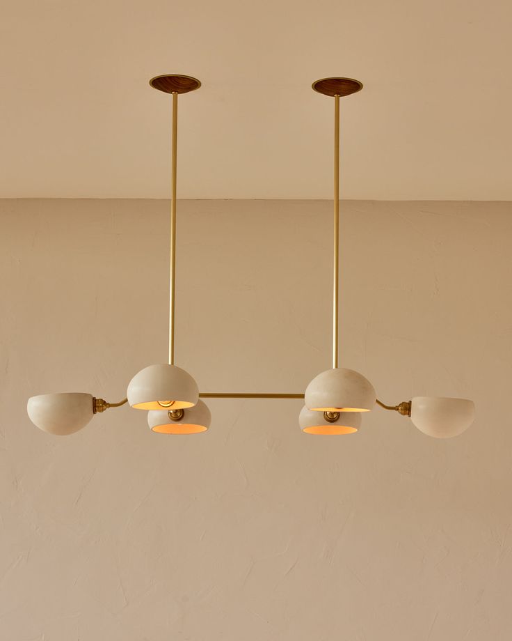 three lights hanging from the ceiling in a room