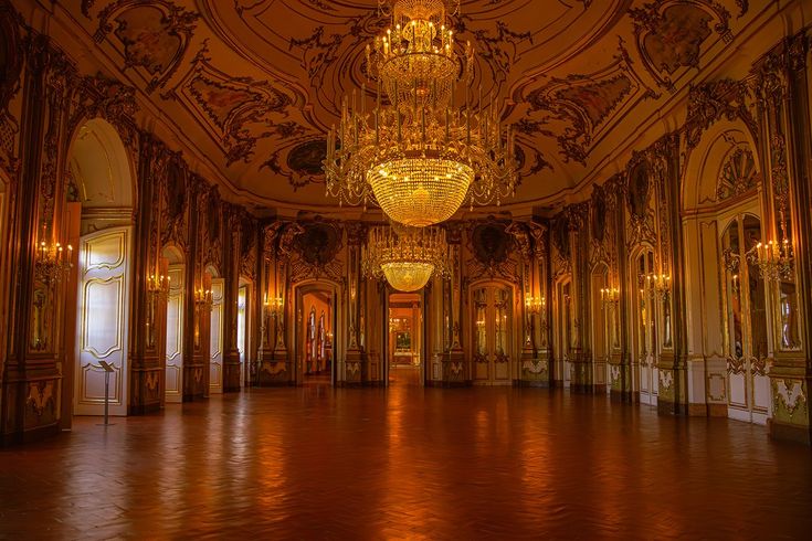 an ornate ballroom with chandeliers and mirrors