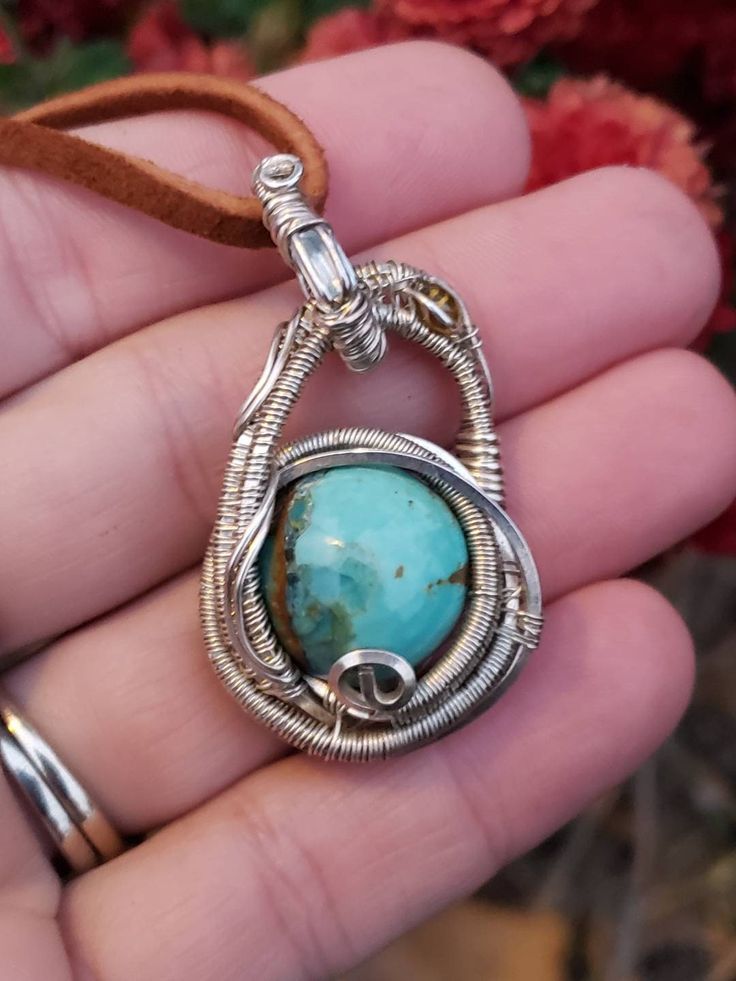 This little pendy has been handmade with love! Nice beautiful Turquoise Cabochon wrapped in Sterling silver wire with Aquamarine and Tourmaline accents. American Turquoise has some inclusions on the front not 100% sure what the other mineral is but possibly flourite? Unique swinging design! This pendant is in the smaller medium size range. 43mm tall and 24mm from to side. Wire wrap has a simple pattern. Simple but beautiful, this wrap is perfect for gifting! I wrap all my pendants by hand, the o Artisan Wire Wrapped Chrysocolla Jewelry, Hand Wrapped Turquoise Sterling Silver Jewelry, Hand Wrapped Sterling Silver Turquoise Jewelry, Artisan Adjustable Wire Wrapped Turquoise Necklace, Unique Wire-wrapped Turquoise Pendant Necklace, Wire Wrapped Turquoise Pendant Necklace, Artisan Adjustable Turquoise Necklace Wire Wrapped, Artisan Wire Wrapped Turquoise Necklace Gift, Unique Wire Wrapped Turquoise Pendant Necklace