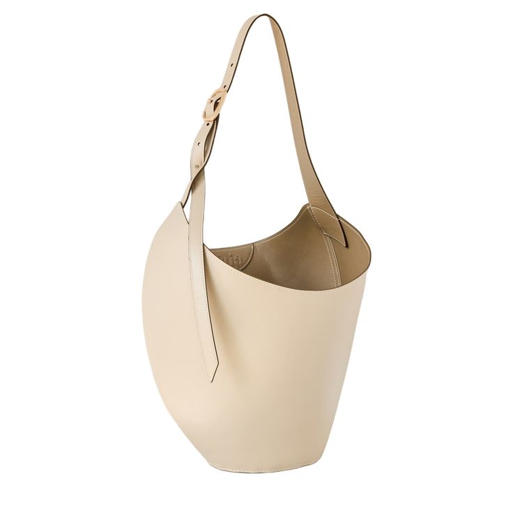 Cult Gaia's Odette Tote Is Crafted Of Leather. This Sleek Style Is Finished With A Thick Strap, Flat Bottom, And A Logo-Detailed Interior. Adjustable Shoulder Strap Dust Bag Included 100% Cow Leather Lining: 100% Polyurethane Spot Clean Imported Size About 7.4" D X 16.3" W X 23.5" L Designer Beige Leather Hobo Bag, Modern Beige Leather Hobo Bag, Elegant Beige Bucket-shaped Hobo Bag, Beige Leather Bucket Bag With Leather Lining, Beige Leather Bucket Bag With Lining, Evening Beige Leather Hobo Bag, Chic Bucket-shaped Bag With Leather Lining, Beige Bucket Shoulder Bag With Leather Lining, Beige Leather-lined Bucket Shoulder Bag