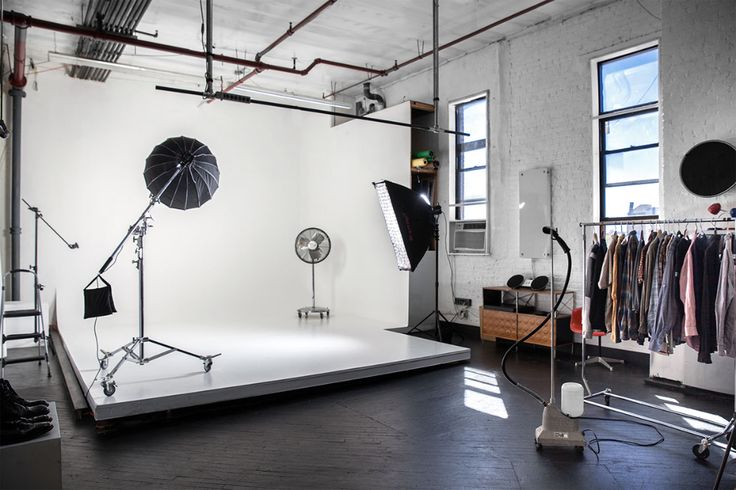 a photo studio with lighting equipment and clothes