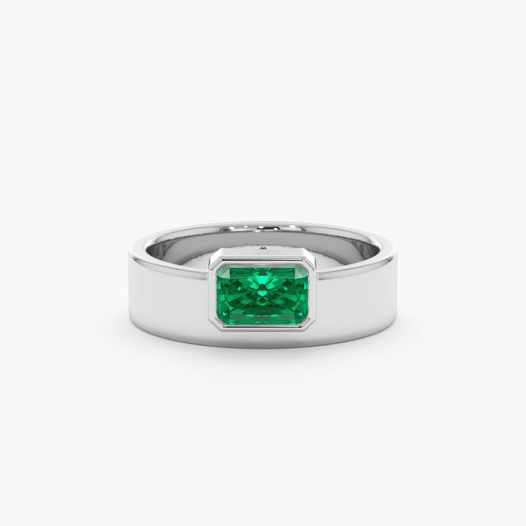 Geneva Unveil your bold style with the Off-Center Emerald Statement Ring. This eye-catching ring showcases a vibrant natural emerald, the May birthstone, in a captivating off-center setting. Crafted in lustrous 14k or 18k solid gold, the thick band adds a contemporary touch while maintaining minimalist elegance. - Handmade- Solid Gold- Natural Emerald- Total Emerald Carat Weight: 0.49 ctw- The Height of the Setting: 2.93 mm- Width of the Setting with the Band: 7.12 mm- The Width of the Band: 5.7 Modern Emerald Jewelry With Center Stone, Modern Emerald Rings With Center Stone, Modern Emerald-cut Green Diamond Ring, Modern Diamond Ring For May Birthstone, Modern Green Rings With Prong Setting, Modern Green Diamond Promise Ring, Modern Green Diamond Anniversary Ring, Modern May Birthstone Diamond Ring, Fine Jewelry Emerald Cut Signet Ring With May Birthstone