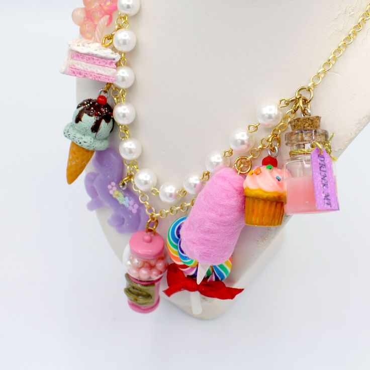 This kawaii statement necklace is called Pink Candy Shop and is a perfect cute charm jewelry gift for any woman in your life including your best friend (or yourself, let's be honest). This piece has been handmade from resin, clay and high quality metal components and features hand painted charms for a quality piece that will be a cute go-to in any charm lovers jewelry collection! Details & Measurements:-Handmade Necklace-High quality glass pearls-Hand-painted charms made from resin & polymer clay-Gumball machine has free floating beads inside! (note it is partially made from glass and fragile)-Choose Gold or Silver Finish -Choose 5, 7 or 9 charms (see list below to find out what charms come on each option)-Charms are chunky and are 1-2" in size (2.5-5cm)-19" (47.5cm) total Necklace Length- Playful Charms Jewelry For Birthday, Handmade Dangle Charm Necklaces For Birthdays, Cute Charms Necklace For Gift, Cute Charms Necklaces For Gifts, Cute Charms Necklaces As Gift, Kawaii Dangle Earrings For Birthday, Kawaii Dangle Jewelry For Valentine's Day, Trendy Cute Jewelry For Gifts, Trendy Jewelry With Cute Design For Gift