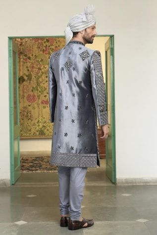 Blue velvet sherwani with thread embroidered geometric and floral patterns highlighted by stone embellishments. Comes with inner kurta and churidar. - Aza Fashions Fitted Anarkali Bandhgala With Mirror Work, Anarkali Sherwani With Mirror Work For Diwali, Wedding Blue Sherwani With Mirror Work, Ceremonial Sherwani With Mirror Work For Eid, Fitted Anarkali Sherwani With Naqshi, Blue Anarkali Sherwani For Eid, Blue Anarkali Sherwani With Straight Kurta, Blue Anarkali Sherwani For Diwali, Fitted Anarkali Style Blue Sherwani