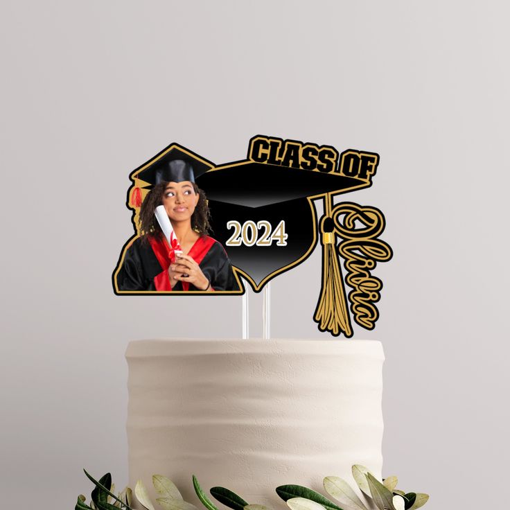 a cake topper with a graduate's cap and tassel