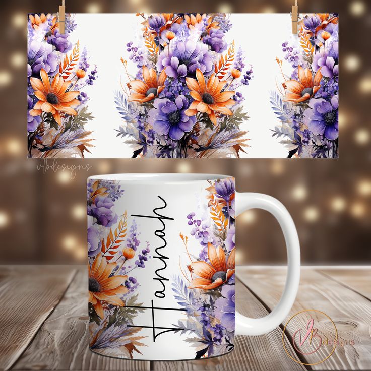 a coffee mug with flowers on it sitting on a wooden table next to string lights