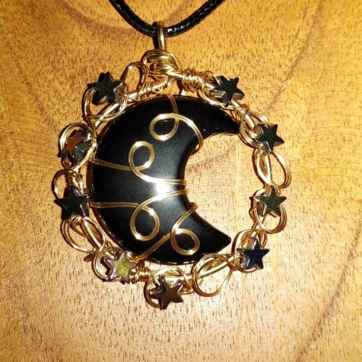 This Is Absolutely Amazing.. I Feel So Strongly About This Beautiful Obsidian Crescent Moon That Is Wire Wrapped In A Bright Goldtone Wire.. With Purplish Stars As Accent Stones.. This Is A Perfect Addition To Your Personal Jewelry Collection.. Don't Miss Out On This Beauty.. Crescent Moon Wire Wrap, Black Moon Charm Jewelry For Festivals, Black Moon Phase Necklaces For Festival, Black Moon Phase Necklace For Festival, Black Jewelry With Moon Charm For Festivals, Black Crescent Jewelry For Festival, Mystical Black Jewelry Gift, Mystical Black Jewelry For Gifts, Black Moon Phase Jewelry For Festivals