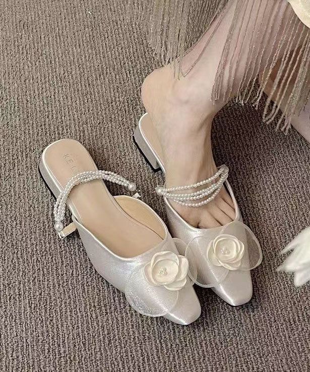 Indulge in the luxury of our French Apricot Pearl Floral Satin Slide Sandals, crafted with exquisite detail and sophistication. Slip into sophistication with these sandals that feature a delicate floral pattern adorned with lustrous pearls, all set on a smooth satin material.Made of:-Satin Upper.-Rubber sole- cushioned insole.0.78"/2cm Heel