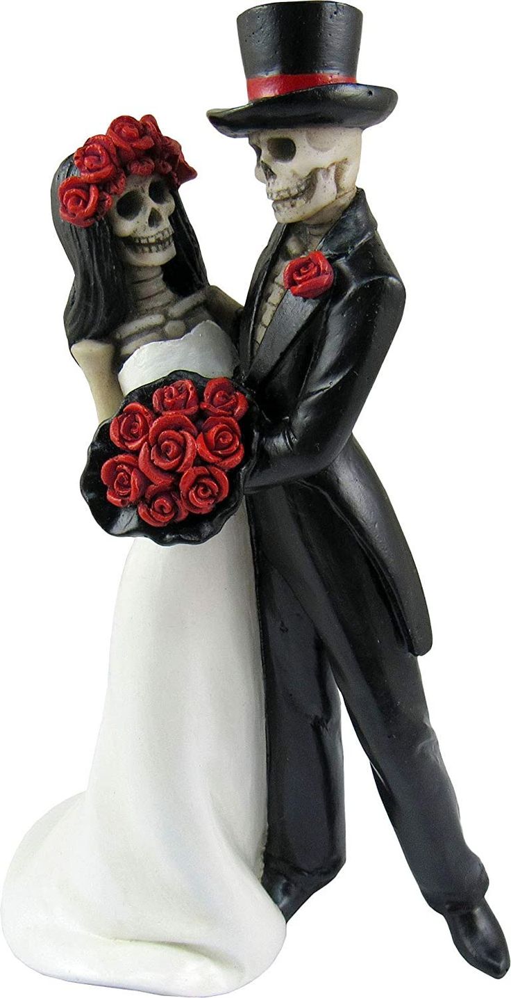 a wedding cake topper with a bride and groom holding red roses in their hands