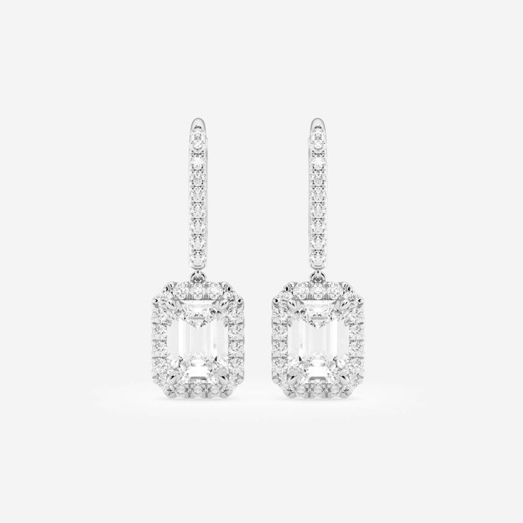 Let these emerald cut diamond earrings drop from your ears and scream out style. Each lab grown emerald shaped diamond is surrounded by round stones to create a halo effect. Beautiful diamond set lever backs are easy to slip on and sit securely on your ears. We suggest wearing these at a cocktail party, wedding dinner or even a summer soiree. Diamond White Baguette Cut Halo Earrings, Diamond White Baguette Cut Earrings With Halo Design, Fine Jewelry Emerald Cut Baguette Diamond Earrings, Emerald Cut Diamond Accented Formal Earrings, Emerald Cut Diamond Accent Earrings For Formal Events, Modern Emerald Cut Diamond Earrings, Fine Jewelry Earrings With Baguette Diamonds In Emerald Cut, White Diamond Baguette Cut Earrings, White Baguette Cut Diamond Earrings