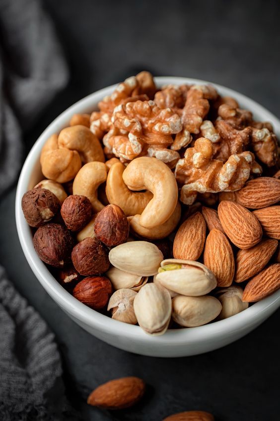 a bowl filled with nuts on top of a table