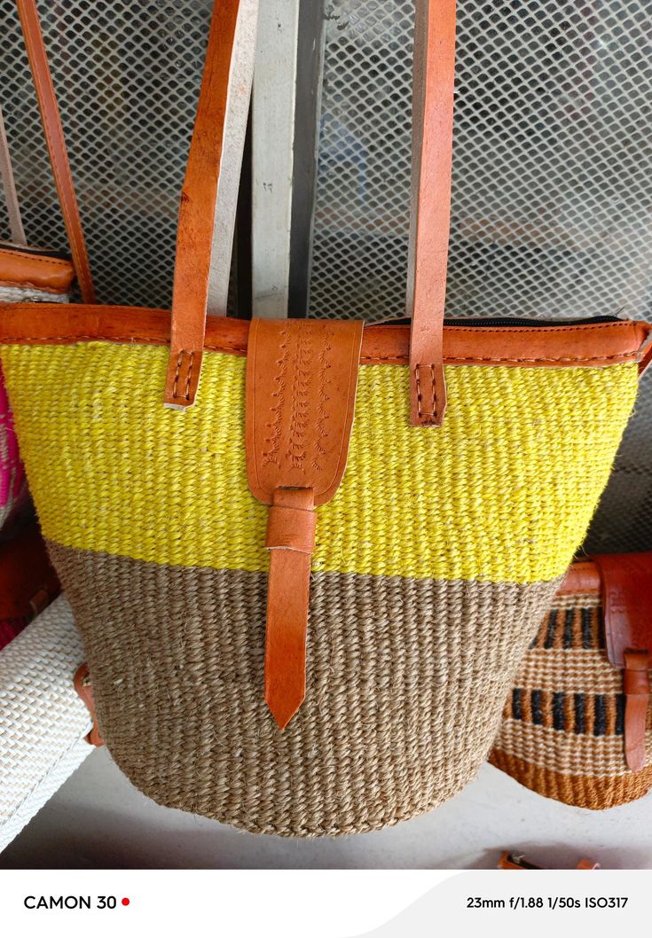 a yellow and brown handbag hanging from the ceiling