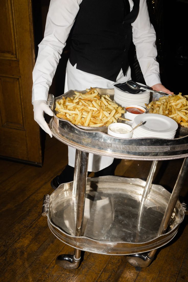 a woman holding a tray with food on it