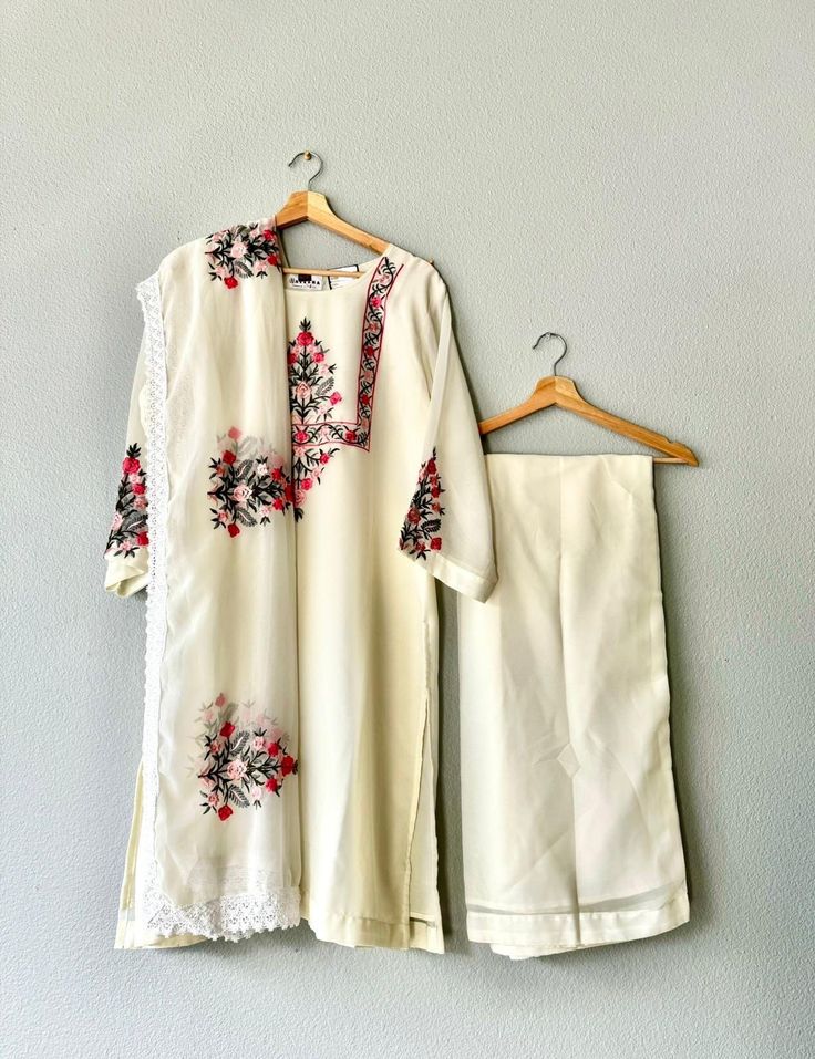 This beautiful ivory and floral kurta set will add elegance and comfort to any occasion. It is in size XXL (India). Set comes with top, pants, and dupatta. Off-white Palazzo Set With Dupatta And Straight Kurta, Bollywood Style Floral Embroidery Pant Set For Eid, Bollywood Pant Set With Floral Embroidery For Eid, Bollywood Style Floral Embroidered Pant Set For Eid, Embroidered Anarkali Pant Set For Spring, Designer Off White Palazzo Set For Eid, Designer Cream Palazzo Set For Eid, Cream Cotton Palazzo Set For Wedding, Designer Cotton Off White Palazzo Set