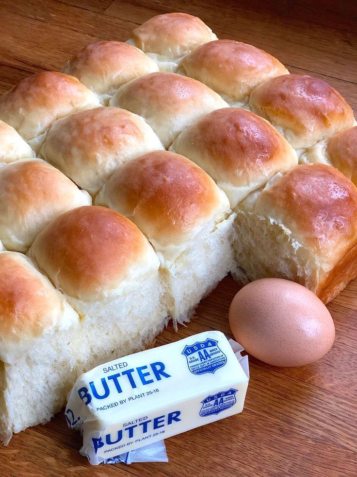 rolls, eggs and butter on a wooden table