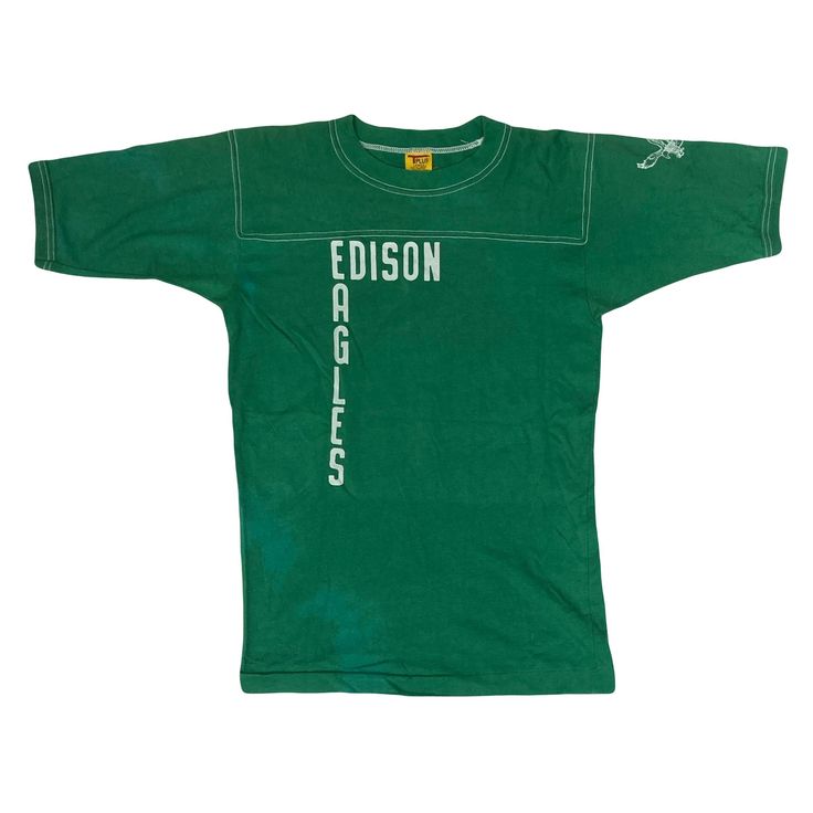 Vintage 70s USA high school football top Edison Eagles green single stitch t shirt size large  Authentic piece from the 70s washed out and faded I places but still very much a good piece of Americana vintage  Size label states large, fits as an oversized medium  Pit to pit: 18.5" Collar to hem: 27.5" Sporty Green Tops For Fan Gear, Green T-shirt For Football Season, Green Sporty T-shirt For Fan Gear, Green College Football Season Tops, Green T-shirt For College Football Season, Green Tops For College Football Season, Green Short Sleeve T-shirt For Game Day, Green Collegiate T-shirt For Sports Events, Collegiate Green T-shirt For Sports Events