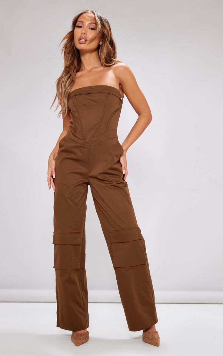 Add some edge to you look with this petite brown corset detail cargo jumpsuit. This jumpsuit is brought to you in a brown material with a cargo style and a figure-flattering corset design, what's not to love This jumpsuit is everything we're loving for you day to night styling. Style with high heels and gold accessories for a look that won't let you down.   Length approx 130cm/51 (Based on a sample size UK 6)   Model wears size UK 6/ EU 34/ AUS 6/ US 2 Romper Outfit With Jacket, Petite Romper, Brown Corset, Brown Jumpsuits, Cargo Jumpsuit, Corset Design, All Black Dresses, Petite Jumpsuit, Bodycon Dresses Casual